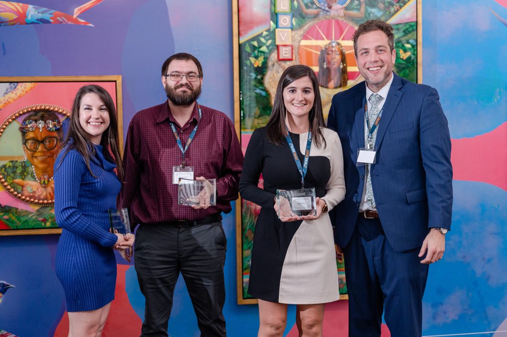 Chelsea, Mike, Mikayla, and Clay posing for the be curious award